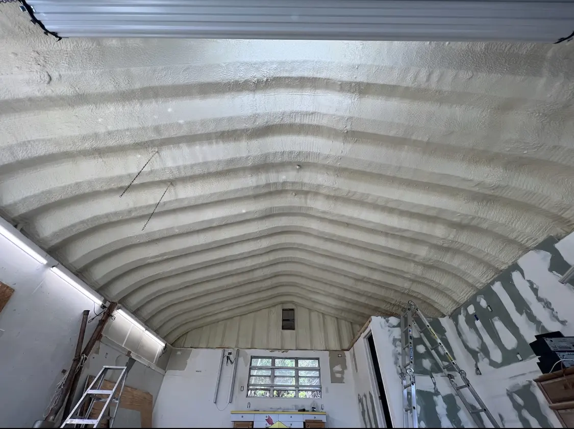 Spray polyurethane foam applied to the underside of a metal roof deck in Delmar